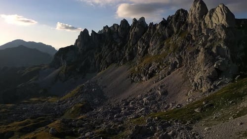 Sharp mountain peaks at sunset. Lots of rocks. Aerial view.