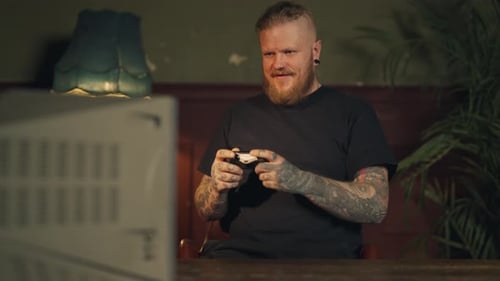 Man Plays Video Games on Retro Television