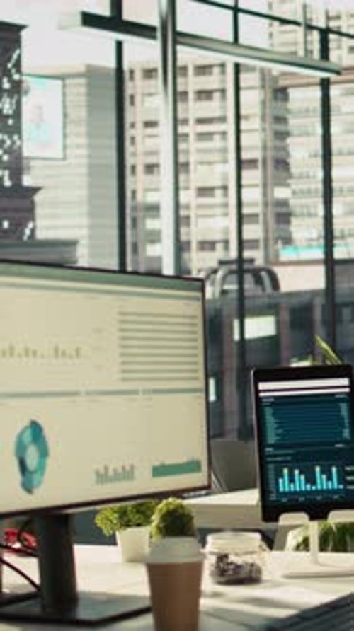 Vertical Video Computer Screen on Office Desk Displaying Financial Charts