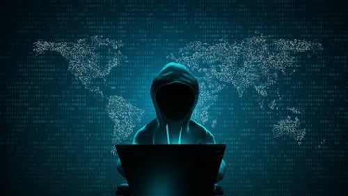 Anonymous Hacker Coding on Laptop with Binary World Map