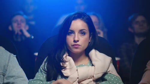 Woman Watching a Movie in a Crowded Theater