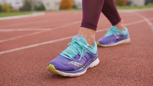 Close-up of Person Walking on Track in Running Shoes