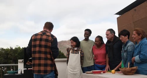 Group of Friends Cooking on Grill Outdoors