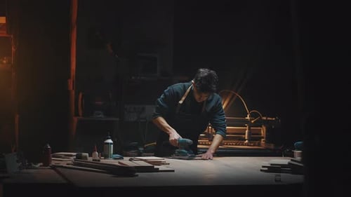 General Plan Cinematic Video of a Carpenter at Work in a Carpentry Workshop The Guy Polishes Wooden