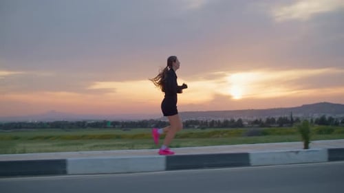 Sporty Woman Running in the Mountains Nature Landscape at Sunset