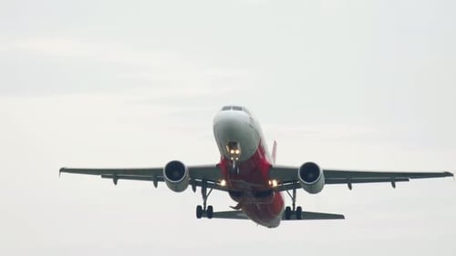 Commercial Airplane Ascends During Flight on Overcast Day