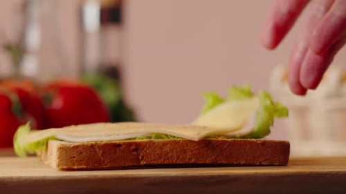 Making a Sandwich with Lettuce and Cheese