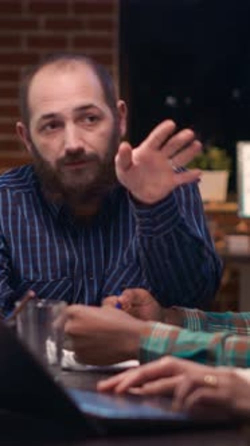 Bearded Man Talking with Colleagues in Office