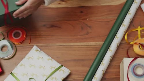 Wrapping Christmas Gifts on Wooden Table
