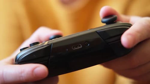 Adult Playing Video Games with Controller Close Up