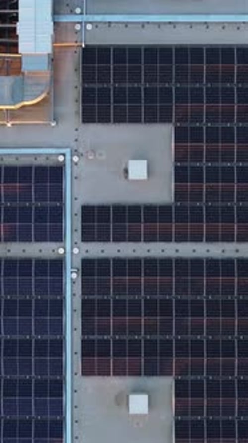 Building Rooftop Featuring Solar Panels in Aerial View
