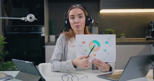 Young Woman Presenting Chart During Virtual Meeting