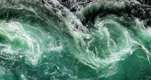 Blue waves of water of the river and the sea meet each other during high tide and low tide.