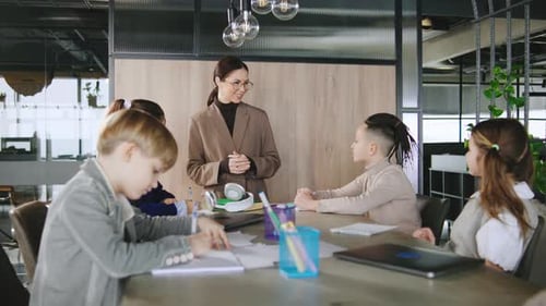 Teacher and Children in Classroom Taking Notes