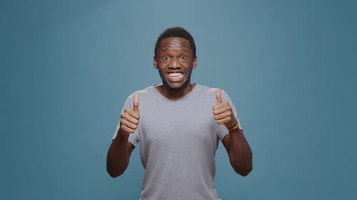 Cheerful Positive Man Doing Thumbs Up Gesture on Camera