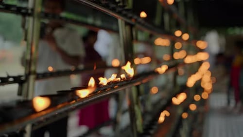 Rows of Oil Lamps Burn Brightly in Sacred Buddhist Temple Devotees Offer Prayers Light Flames As