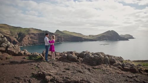 Couple Embracing on Cliff Overlooking Ocean in Madeira
