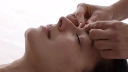 Woman Receiving Gentle Face Massage for Relaxation