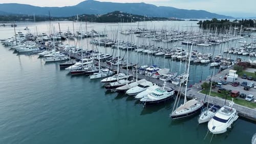 Panoramic aerial view of large yacht marina filled with sailboats and masts at dusk in Mediterranean