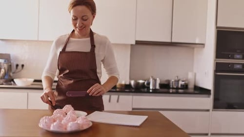 Woman Preparing Meringues in a Bright Kitchen