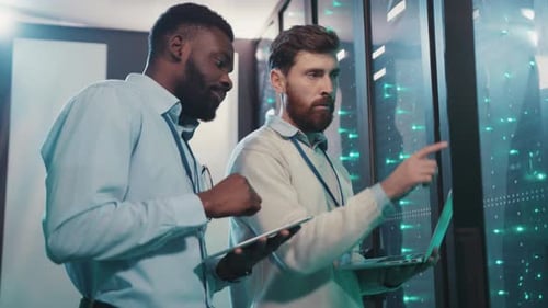 Technicians Working in Data Center with Laptop, Tablet