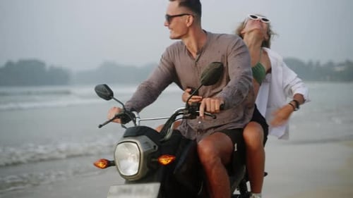 Happy People Ride Motorbike on Seaside Couple in Love Have Fun Driving Motorcycle on Ocean Coast