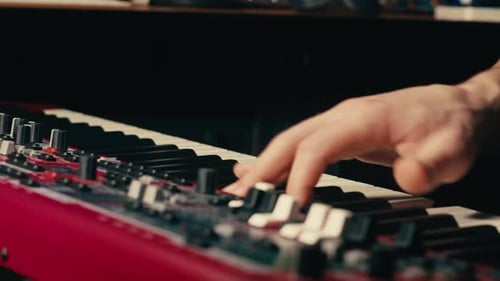 Close Up of Keyboard Player Hands Playing Rock Music with Keyboard at the Concert in Studio