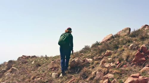 Man hiker adventure on trail mountains with backpack and trekking poles, healthy lifestyle