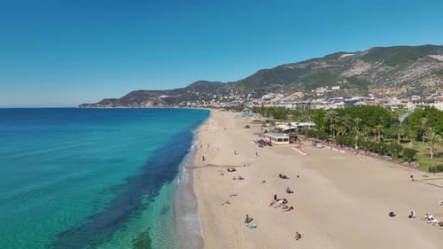 Aerial Video Beautiful Coastal Beach With White Sand and Vibrant Azure Water Captured From the Sky