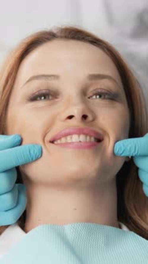 Woman at the Dentist Showing Teeth Smiling