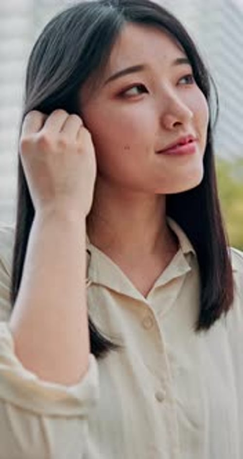 Businesswoman, earphones and music in park for break, streaming and relax with audio app