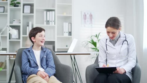 Child at a pediatrician appointment in office. Teen boy visit to the children hospital clinic.
