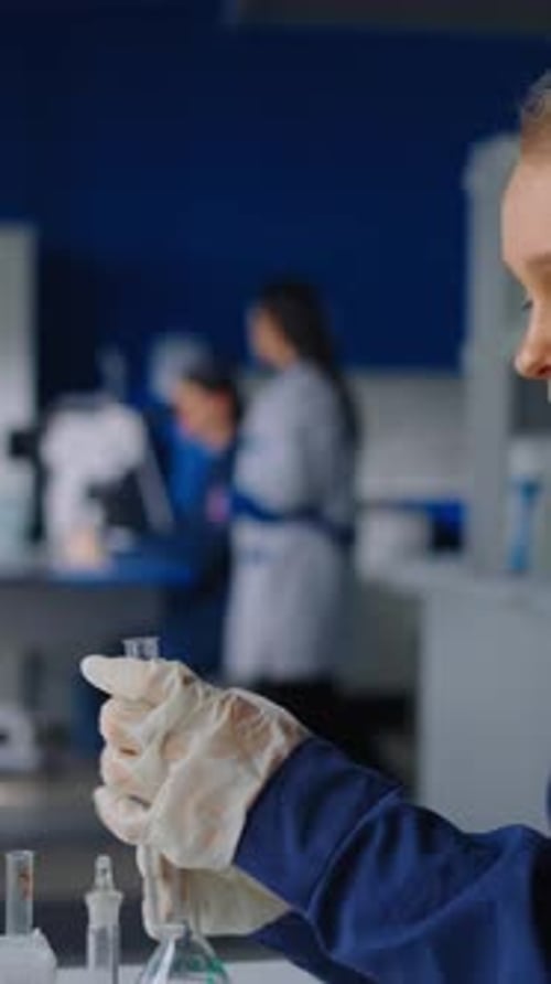 Woman Scientist Working in a Blue-Toned Laboratory