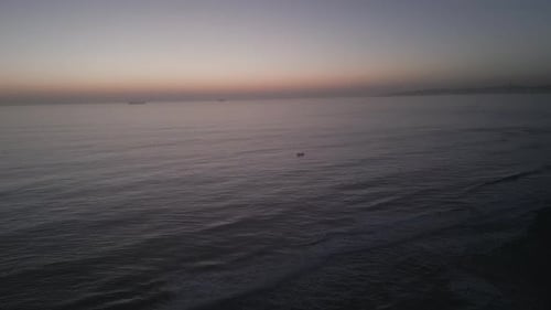 Motor boat with tourist passengers going on a river at beautiful warm sunset with reflections in the