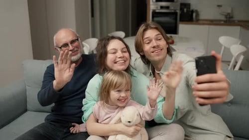 Happy Family Waving During a Joyful Video Call