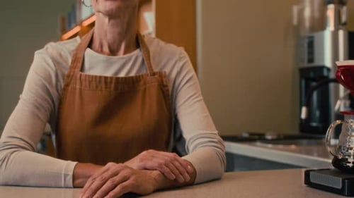 Senior Caucasian Cafe Owner Looking At Camera