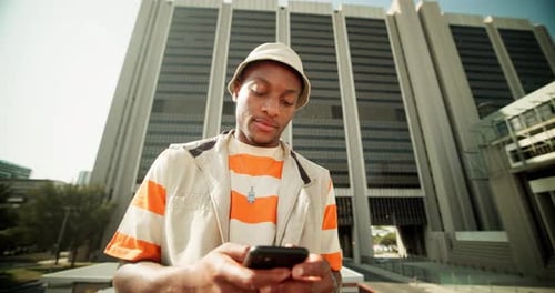 Young Adult Using Phone Outside Office Building