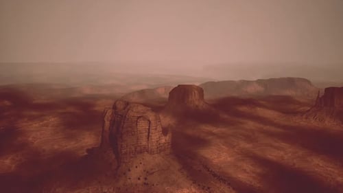 Vast Desert Landscape at Dusk with Eerie Shadows and Red Rock Formations