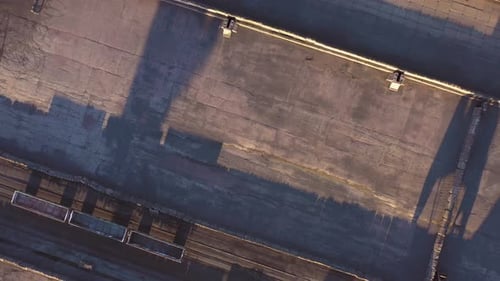 Aerial View From a Drone Flying Over Industrial Zone and the Field