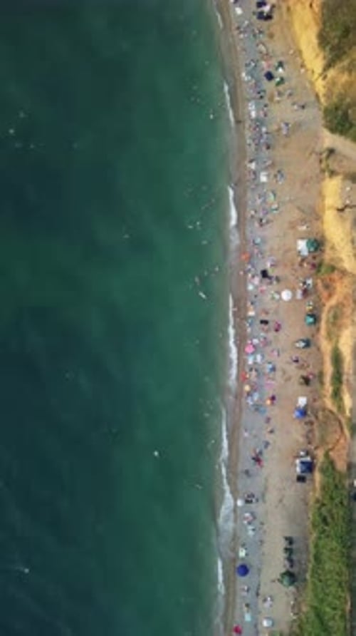 Aerial View of Sandy Beach Swimming People in Sea Bay with Transparent Blue Water at Sunset in