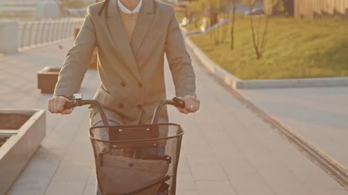 Stylish Person Cycling in Urban Park at Sunset