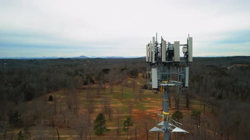 Aerial Reverse Shot of Cell Phone Tower Surrounded by Forest. Drone Footage