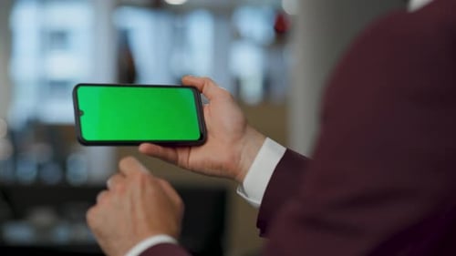 Unrecognized businessman arms searching internet at mobile mockup key in office