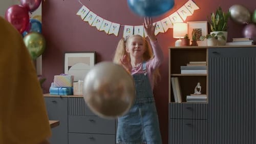 Group of Kids Playing with Balloons During Children Birthday Party