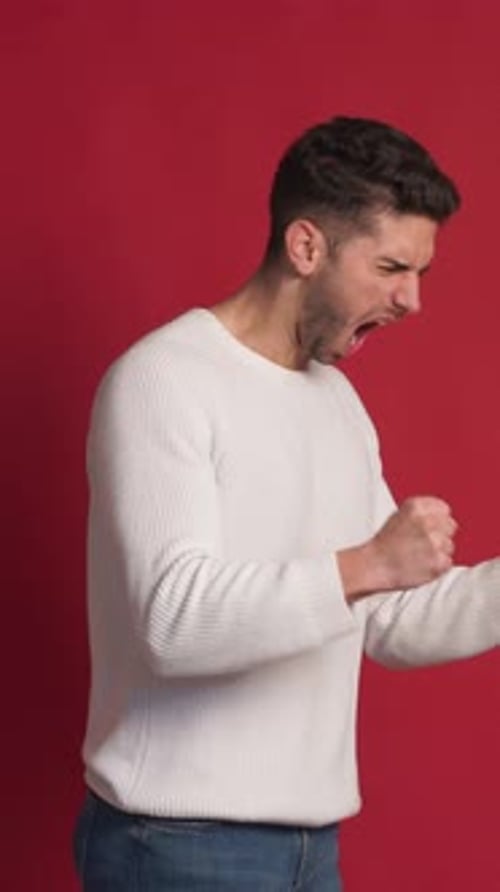 Cheerful Young Man Celebrating and Screaming