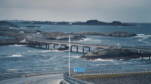 Iconic Atlantic ocean road winding through the archipelago. Powerful waves crash on the rocks and br