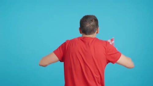 Rear View of a Man Waving a Danish Pennant