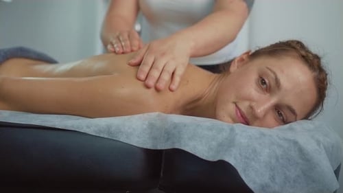 Beautiful Young Slim Woman Having Spa Massage at Back to Relax in Spa Club