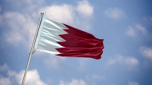 Waving Flag of Bahrain Against Blue Sky