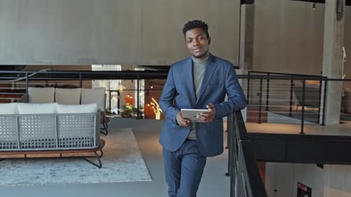 Portrait of Young Black Businessman with Tablet in Office Lobby